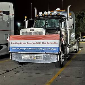Trucking Across America with the Schmitts banner on a semi truck